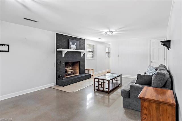 living area featuring visible vents, a fireplace, baseboards, and finished concrete floors