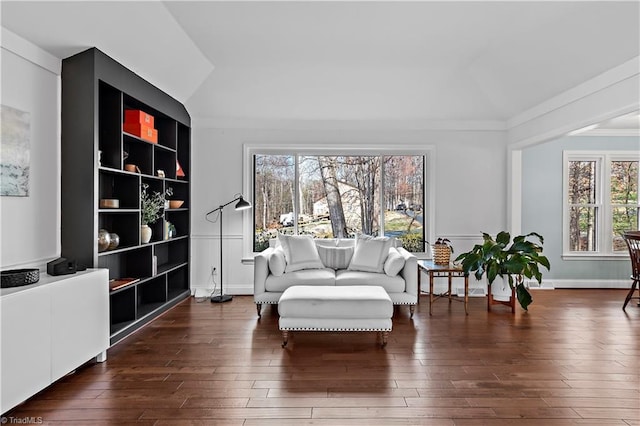 sitting room with vaulted ceiling, baseboards, and dark wood-type flooring