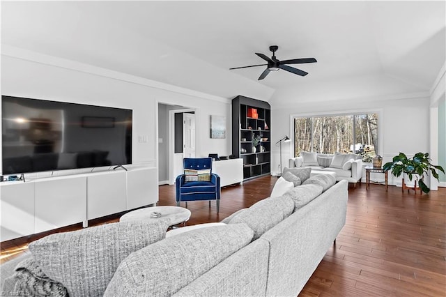 living room featuring lofted ceiling, a ceiling fan, dark wood-type flooring, and baseboards