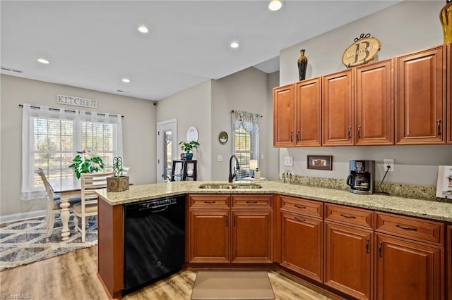 kitchen featuring dishwasher, sink, kitchen peninsula, and light wood-type flooring