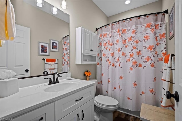 bathroom featuring vanity, wood-type flooring, walk in shower, and toilet