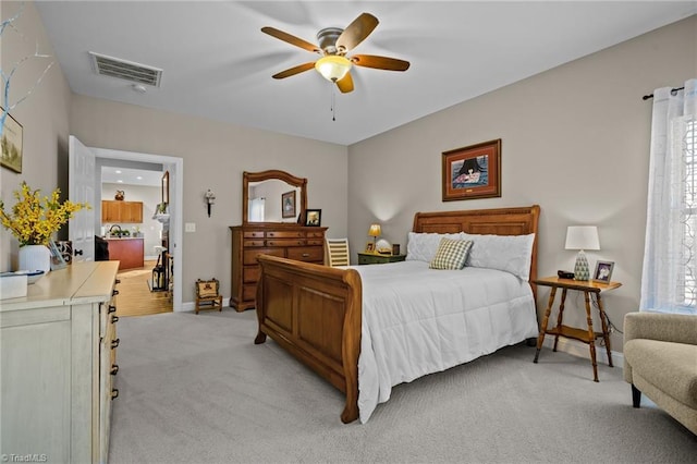 bedroom with ceiling fan and light carpet