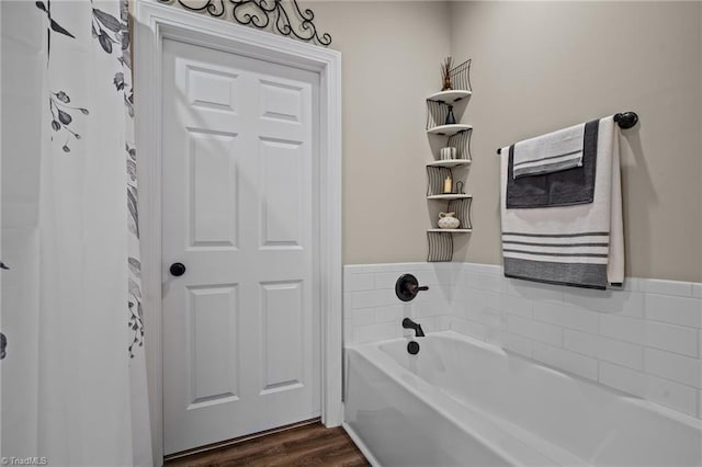 bathroom featuring hardwood / wood-style floors and a tub