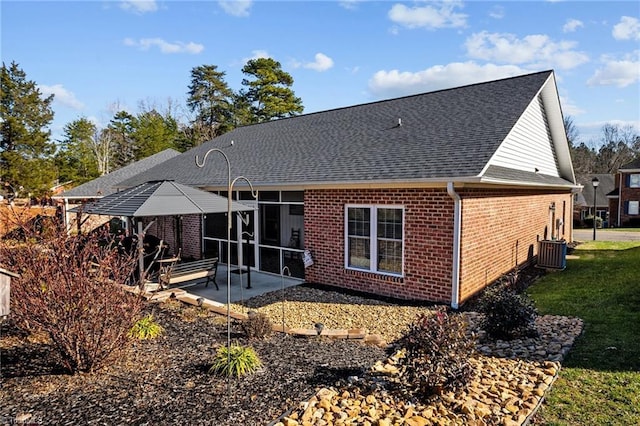 back of property featuring central AC unit and a patio area