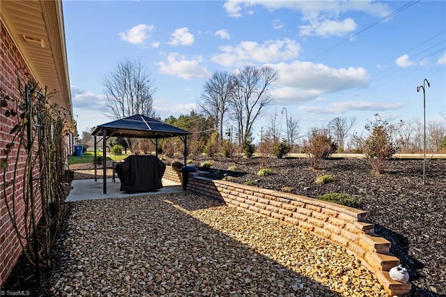 view of yard featuring a gazebo and a patio