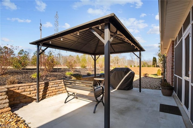 view of patio / terrace featuring a gazebo and a grill