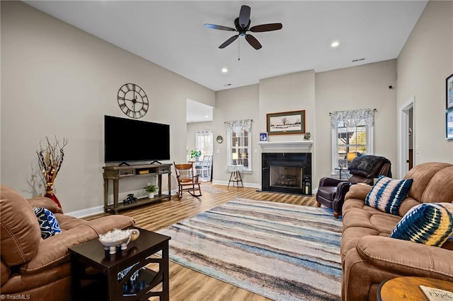 living room with light hardwood / wood-style floors and ceiling fan