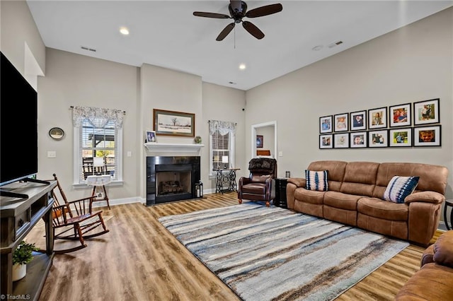 living room featuring ceiling fan and light hardwood / wood-style floors