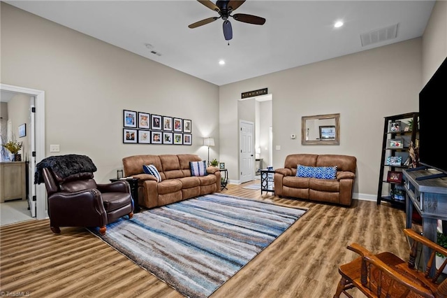 living room featuring ceiling fan and hardwood / wood-style floors