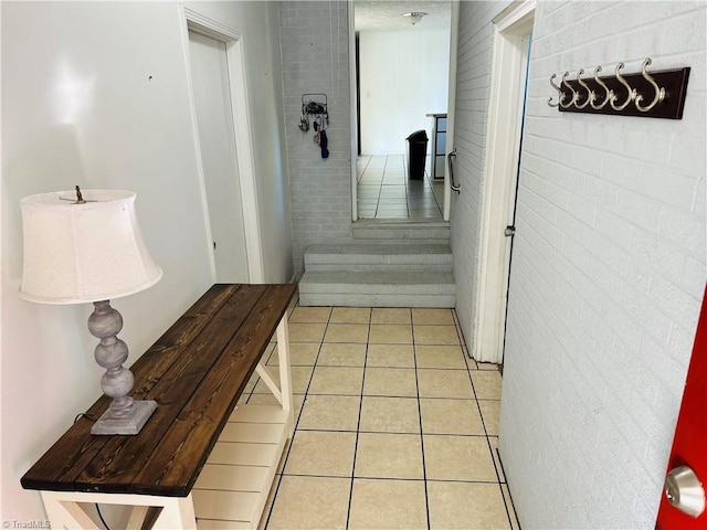 hall featuring light tile patterned flooring