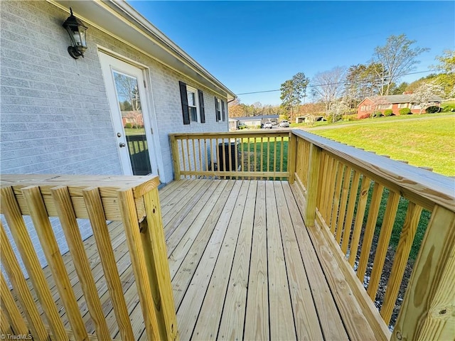 wooden terrace with a yard