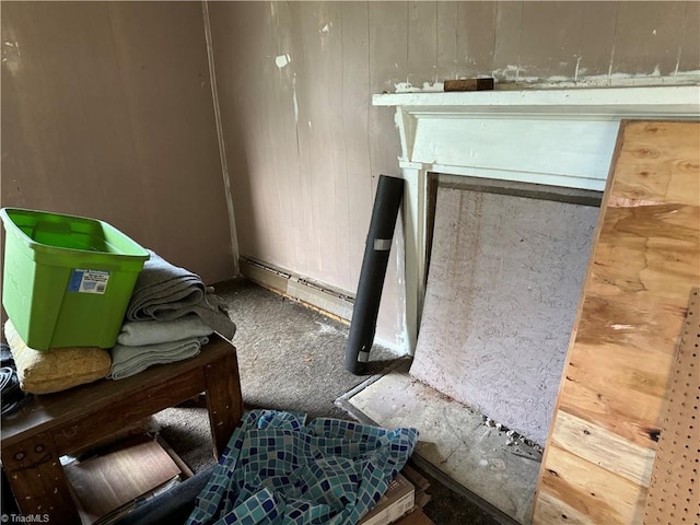 interior space featuring baseboard heating and wood walls