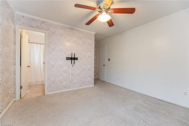 unfurnished bedroom with ceiling fan, crown molding, baseboards, and carpet floors