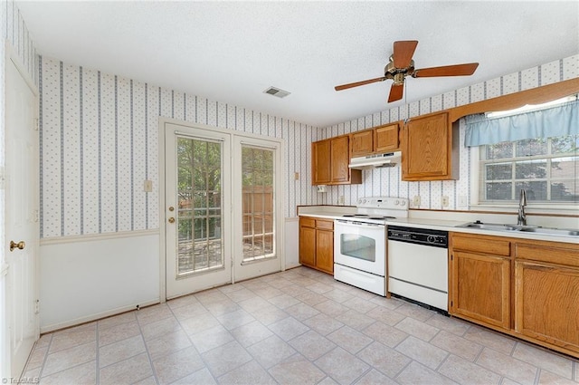1305 Glen Raven Ct, Greensboro, NC 27410 - kitchen with white appliances, wallpapered walls, under cabinet range hood, a sink, and light countertops