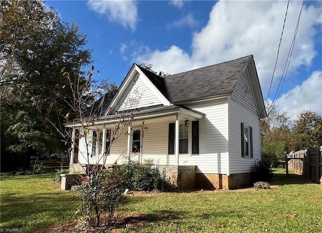 exterior space featuring a porch and a lawn