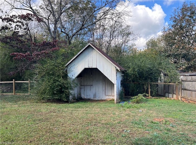 view of outbuilding featuring a yard