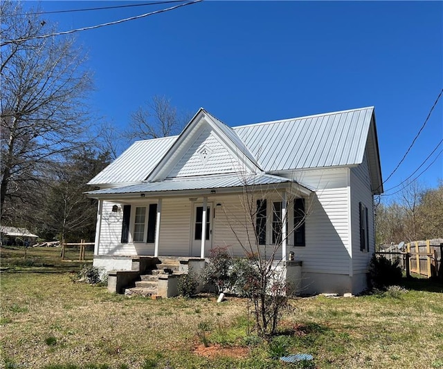 view of front of home with a porch and metal roof