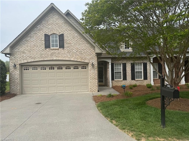 401 Pelican Ln, Clemmons, NC 27012 - view of front of home featuring concrete driveway, brick siding, and a garage