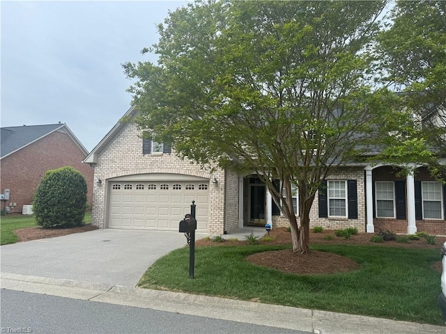 401 Pelican Ln, Clemmons, NC 27012 - obstructed view of property with a garage, brick siding, a front yard, and concrete driveway