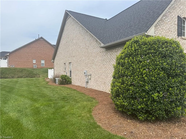 401 Pelican Ln, Clemmons, NC 27012 - view of property exterior with a shingled roof, brick siding, and a yard
