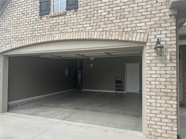 401 Pelican Ln, Clemmons, NC 27012 - garage featuring water heater and concrete driveway