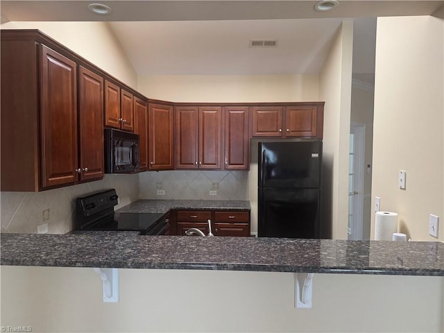 401 Pelican Ln, Clemmons, NC 27012 - kitchen with dark stone countertops, visible vents, decorative backsplash, black appliances, and a peninsula