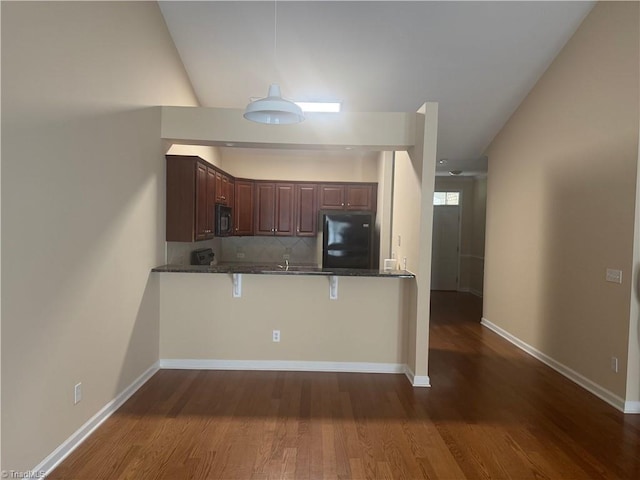 401 Pelican Ln, Clemmons, NC 27012 - kitchen with dark wood finished floors, black appliances, a peninsula, and decorative backsplash