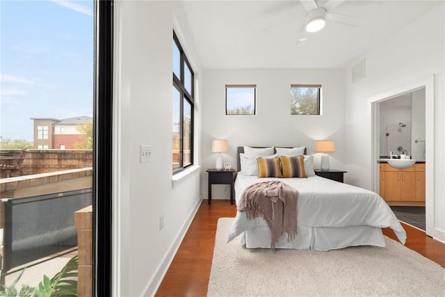 bedroom featuring ceiling fan, dark hardwood / wood-style floors, and multiple windows