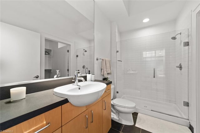 bathroom with vanity, tile patterned flooring, toilet, and an enclosed shower