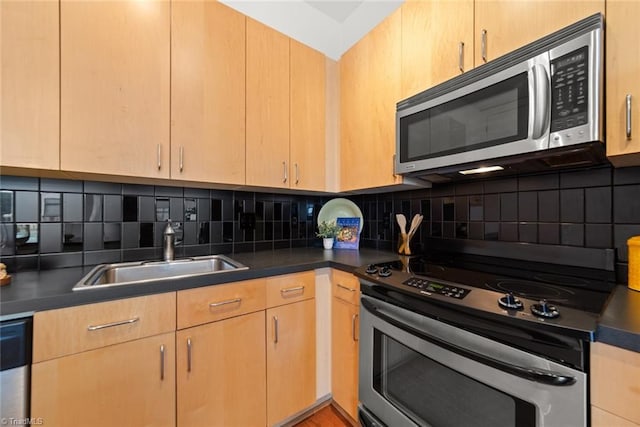 kitchen featuring light brown cabinets, sink, decorative backsplash, and appliances with stainless steel finishes