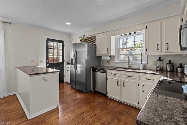 kitchen featuring stainless steel appliances, a wealth of natural light, sink, and white cabinets