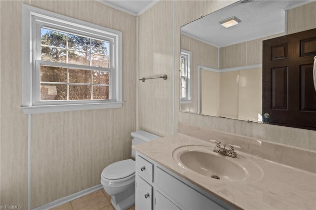 bathroom featuring vanity, ornamental molding, tile patterned floors, and toilet