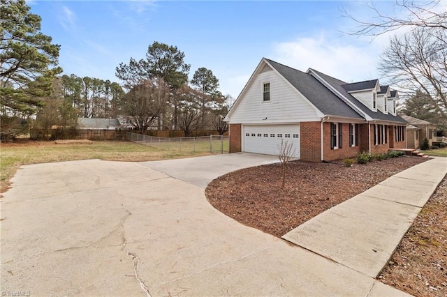 view of side of home featuring a garage and a lawn