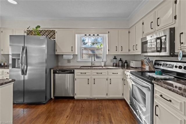 kitchen with white cabinetry, stainless steel appliances, and sink