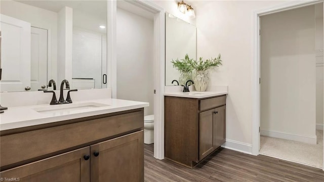 bathroom with vanity, hardwood / wood-style flooring, and toilet