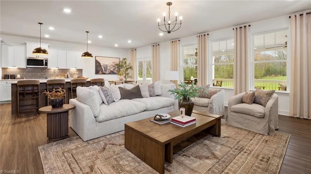 living room featuring hardwood / wood-style floors and an inviting chandelier