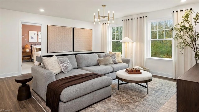 living room with light hardwood / wood-style flooring and a notable chandelier