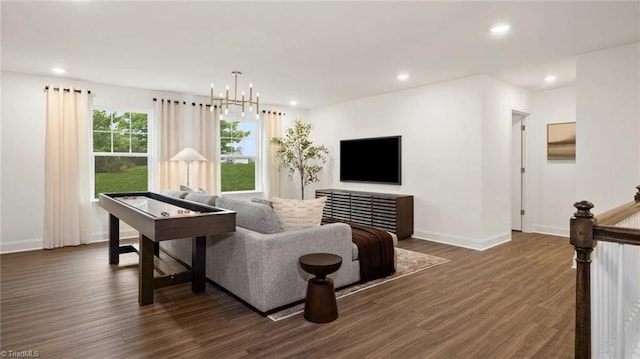 living room featuring a chandelier and dark wood-type flooring