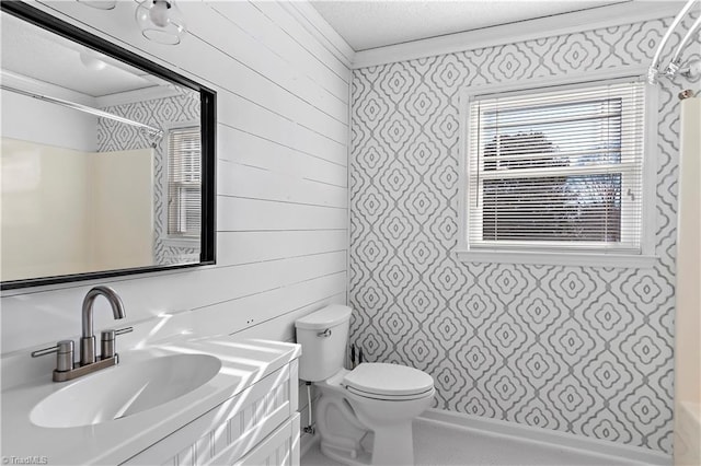 full bathroom with wooden walls, ornamental molding, toilet, shower / bathtub combination, and vanity