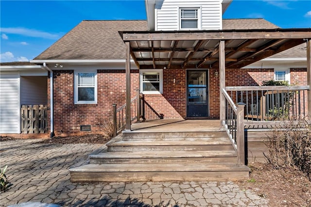 property entrance featuring brick siding, crawl space, and a shingled roof