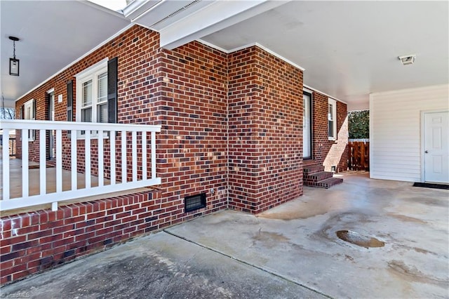 view of side of property featuring crawl space and brick siding