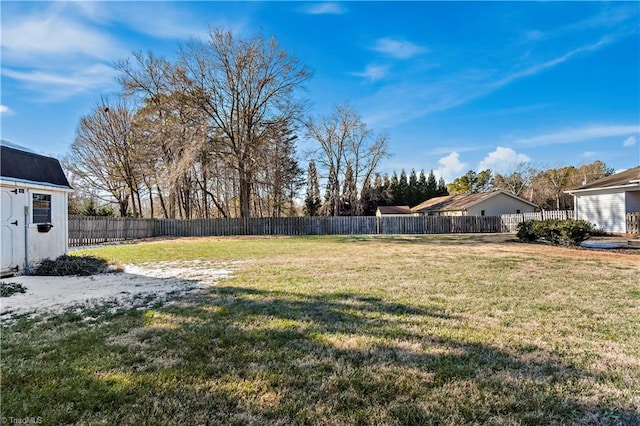 view of yard with fence private yard and an outbuilding