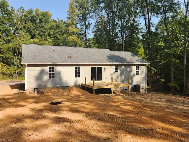 back of property with a deck and central AC unit