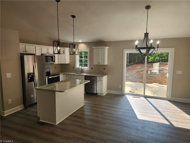 kitchen with sink, dark hardwood / wood-style flooring, hanging light fixtures, stainless steel appliances, and white cabinets