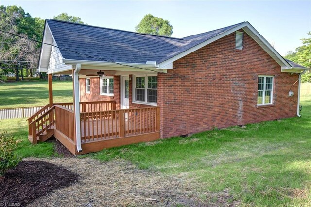 714 Martin St, Greensboro, NC 27406 - rear view of property with a lawn, a deck, roof with shingles, and brick siding