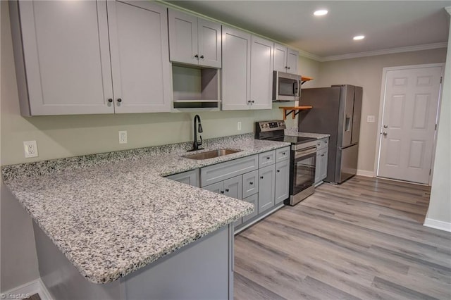 714 Martin St, Greensboro, NC 27406 - kitchen with a peninsula, recessed lighting, light stone counters, a sink, and appliances with stainless steel finishes
