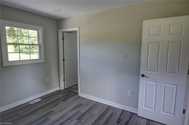 714 Martin St, Greensboro, NC 27406 - spare room featuring baseboards, visible vents, and dark wood finished floors