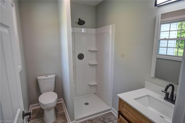 714 Martin St, Greensboro, NC 27406 - bathroom with vanity, baseboards, walk in shower, and toilet