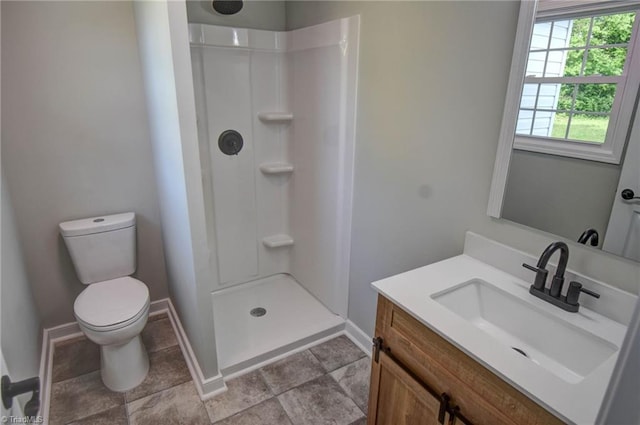 714 Martin St, Greensboro, NC 27406 - bathroom with baseboards, a stall shower, toilet, and vanity