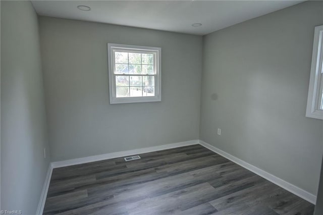 714 Martin St, Greensboro, NC 27406 - unfurnished room featuring baseboards, visible vents, and dark wood-style floors